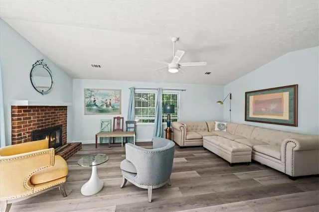 a living room with furniture wooden floor and window