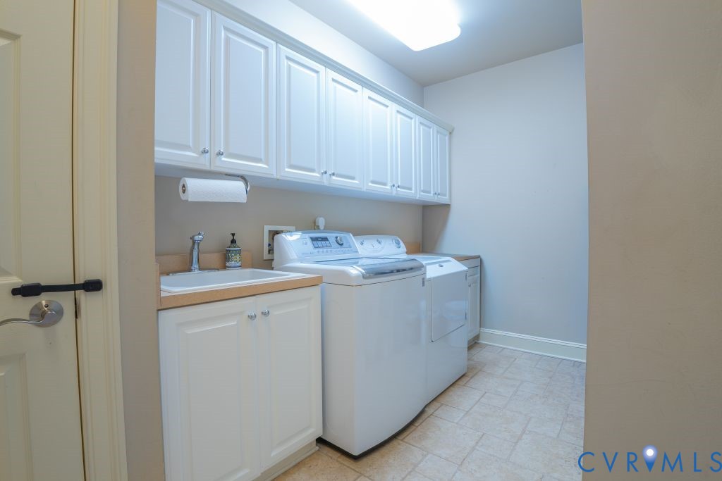 14319 Blunts Bridge Road Ashland, VA 23005 - Photo 21 of 50 First floor laundry with tile flooring, custom cab