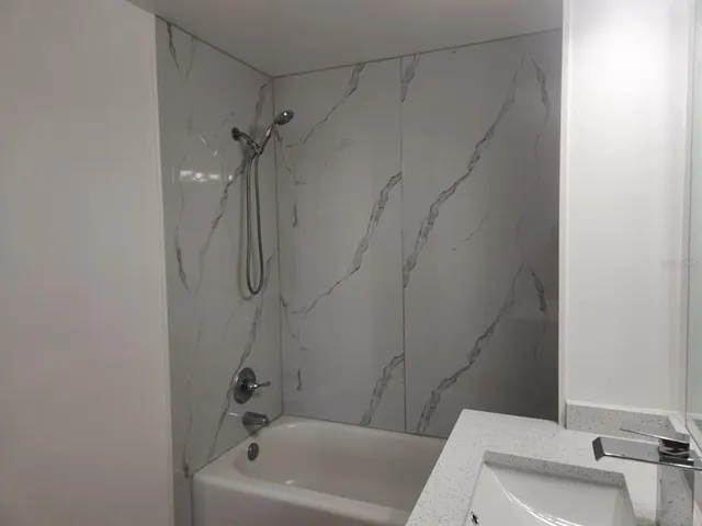a bathroom with a tub and shower