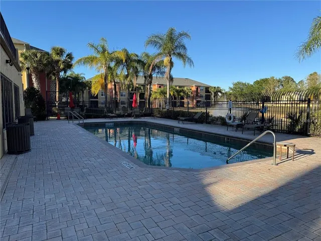 a view of a swimming pool with a table and chairs