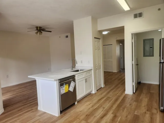 wooden floor with white cabinets
