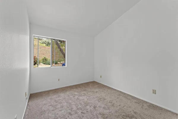 a bedroom with a large bed and a couch