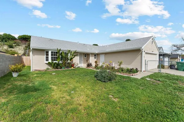 a view of a house with a yard and garage