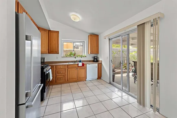 a kitchen with a sink a refrigerator and cabinets
