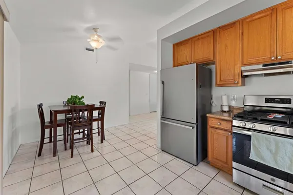 a kitchen with stainless steel appliances a refrigerator and a stove top oven