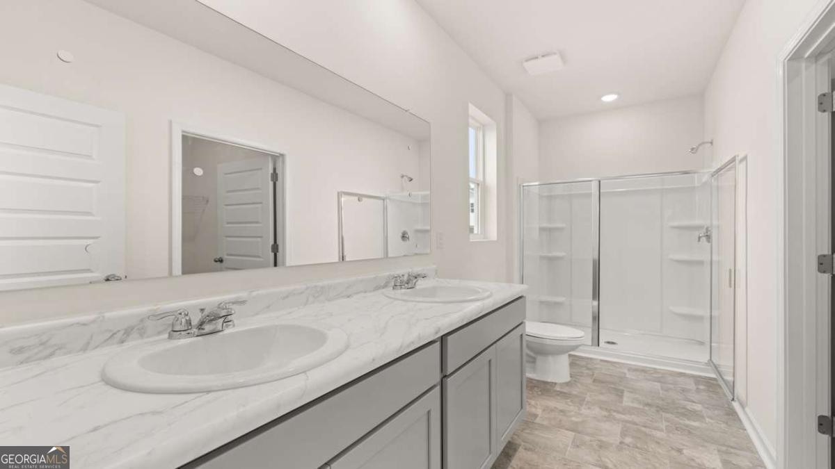 8576 Seabiscuit Road Lithonia, GA 30058 - Photo 14 of 22 a bathroom with a sink and a mirror