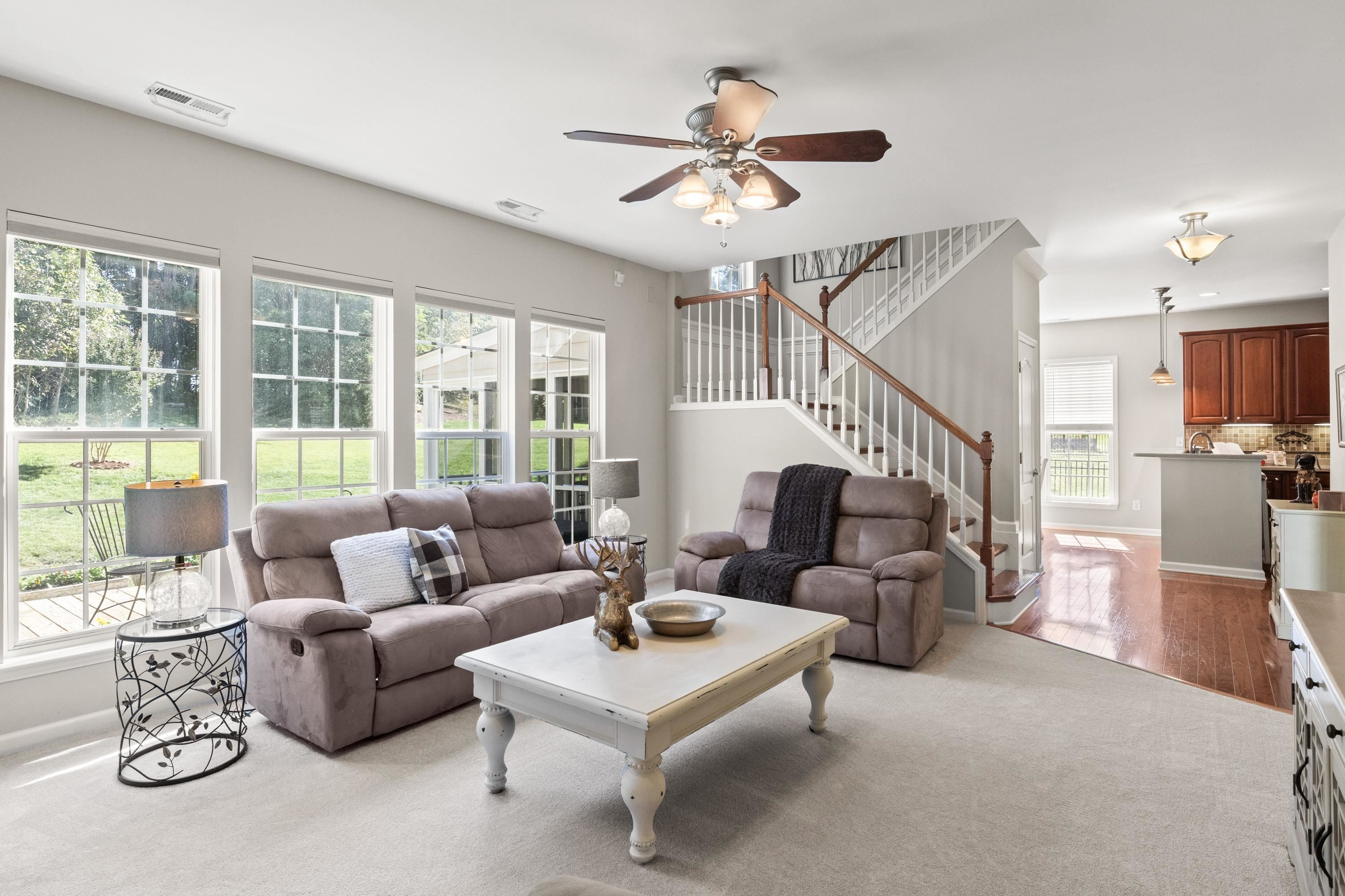 3310 Chrysanthemum Way Raleigh, NC 27614 - Photo 24 of 59 a living room with furniture ceiling fan and a large window