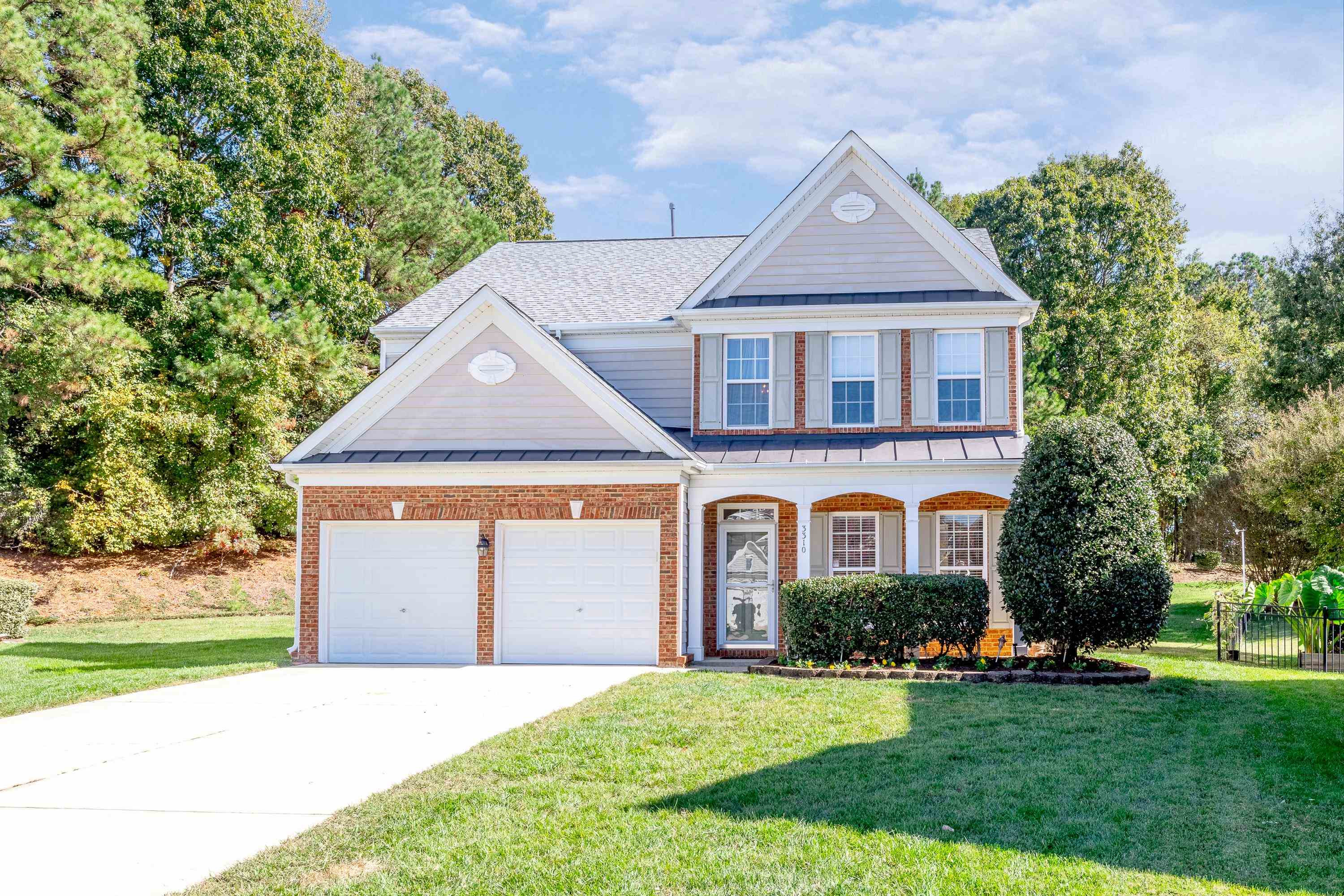 3310 Chrysanthemum Way Raleigh, NC 27614 - Photo 10 of 59 a front view of a house with a yard and garage