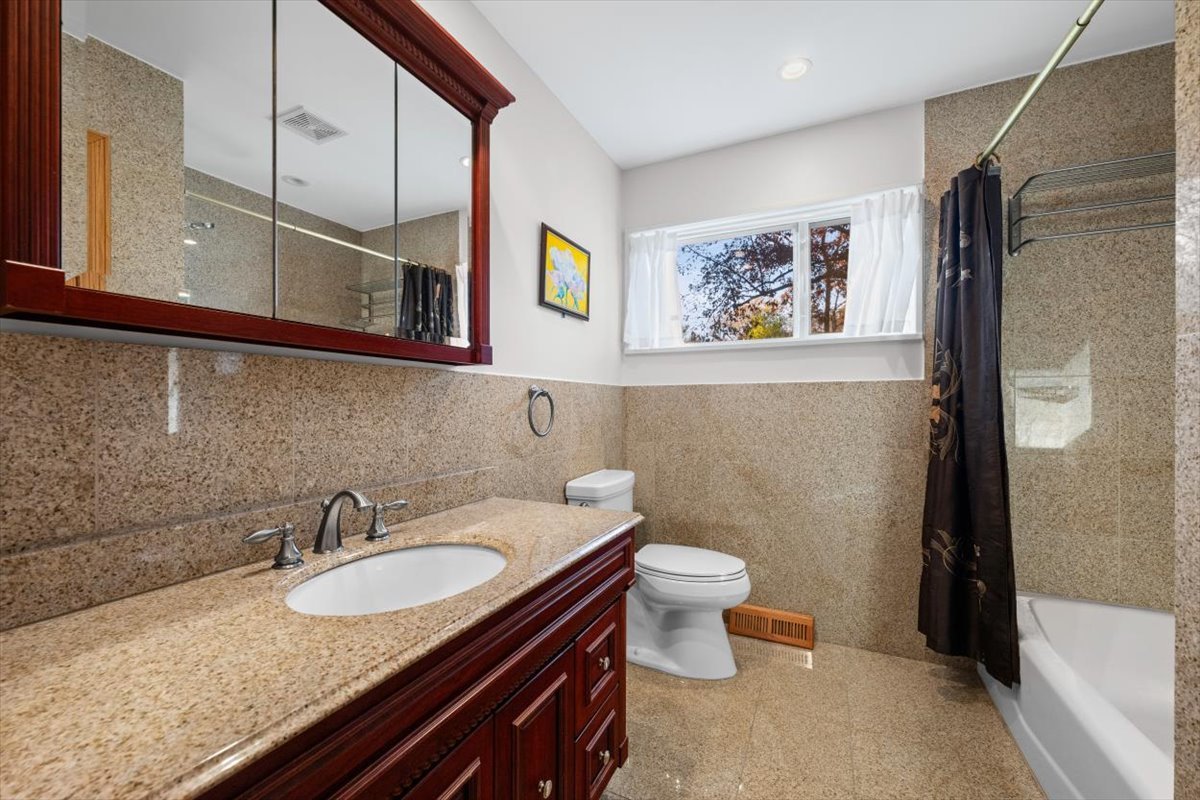 3296 Brook Road Highland Park, IL 60035 - Photo 11 of 21 a bathroom with a granite countertop sink and a mirror