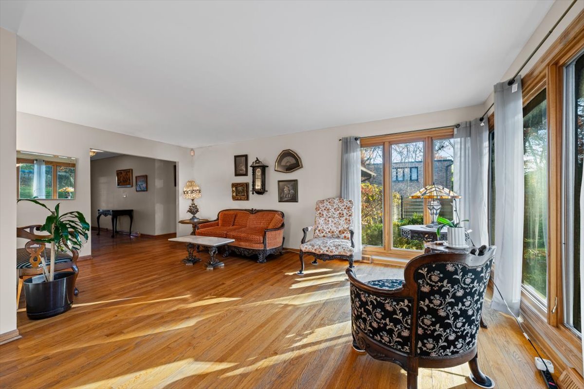 3296 Brook Road Highland Park, IL 60035 - Photo 9 of 21 a living room with furniture floor to ceiling window and potted plant