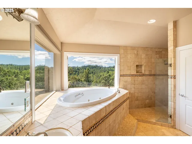 a bathroom with a tub and a shower