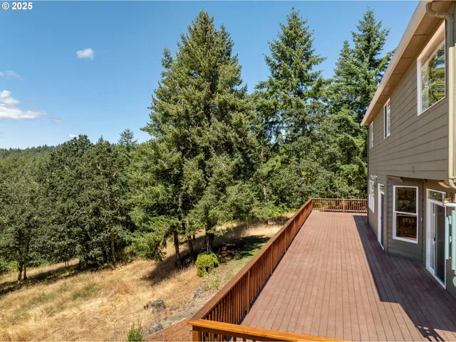 a view of balcony with wooden floor and fence