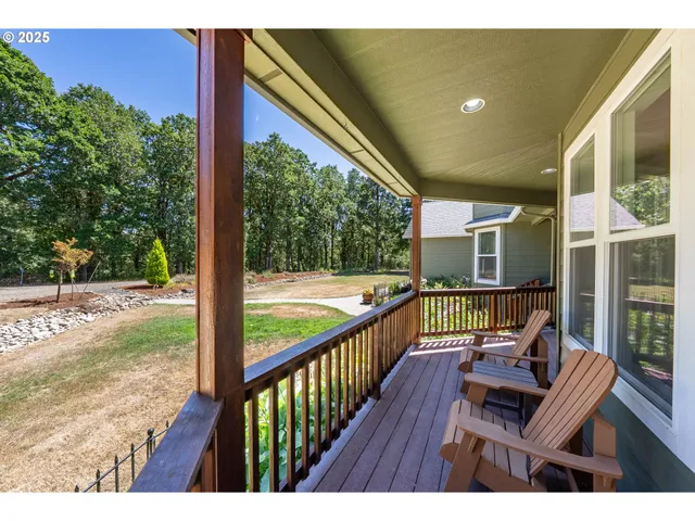 a view of balcony with wooden floor and outdoor seating