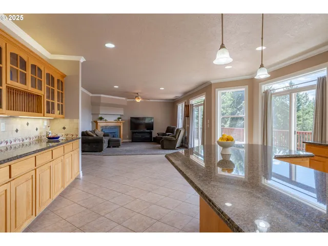 a kitchen with sink and view of living room