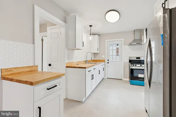 a kitchen with refrigerator and cabinets