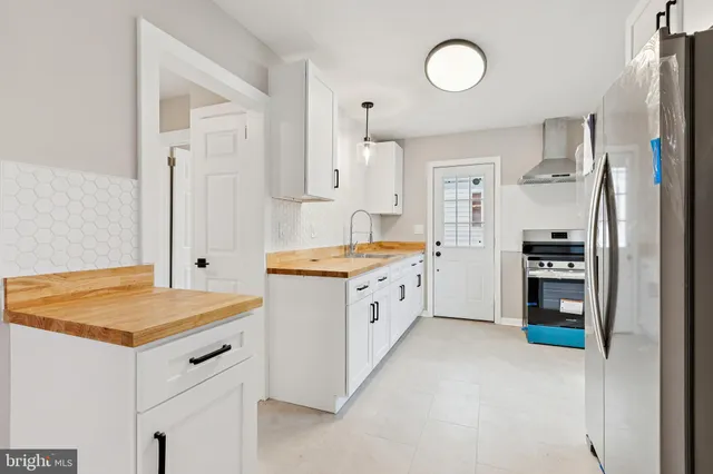 a kitchen with refrigerator and cabinets