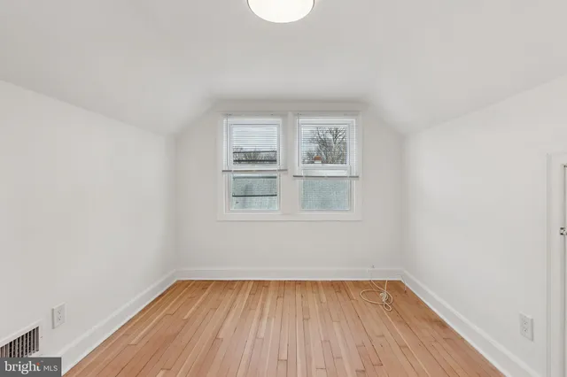 a view of a room with wooden floor and window