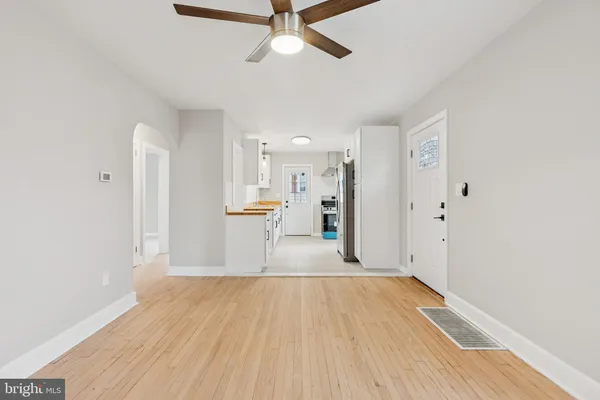 a view of empty room with wooden floor