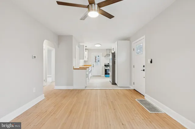 a view of empty room with wooden floor