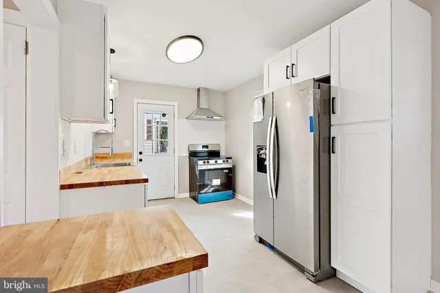 a bedroom with a bed and a refrigerator