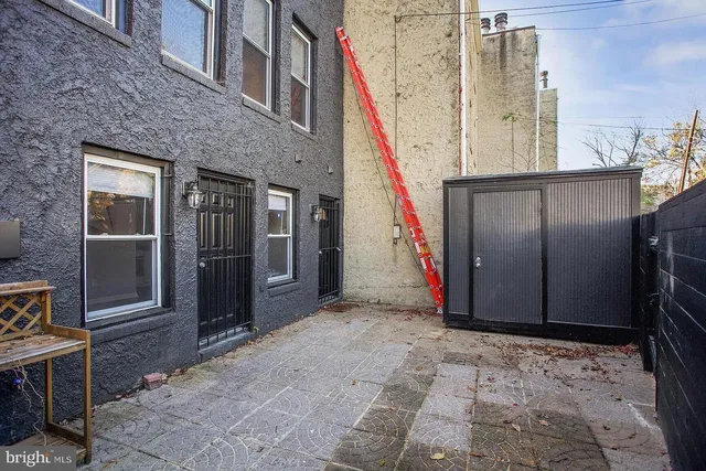 a view of a hallway with wooden fence