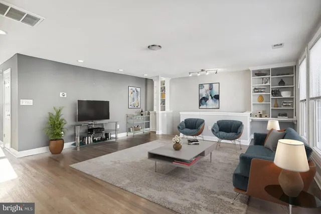a living room with furniture a rug and a flat screen tv
