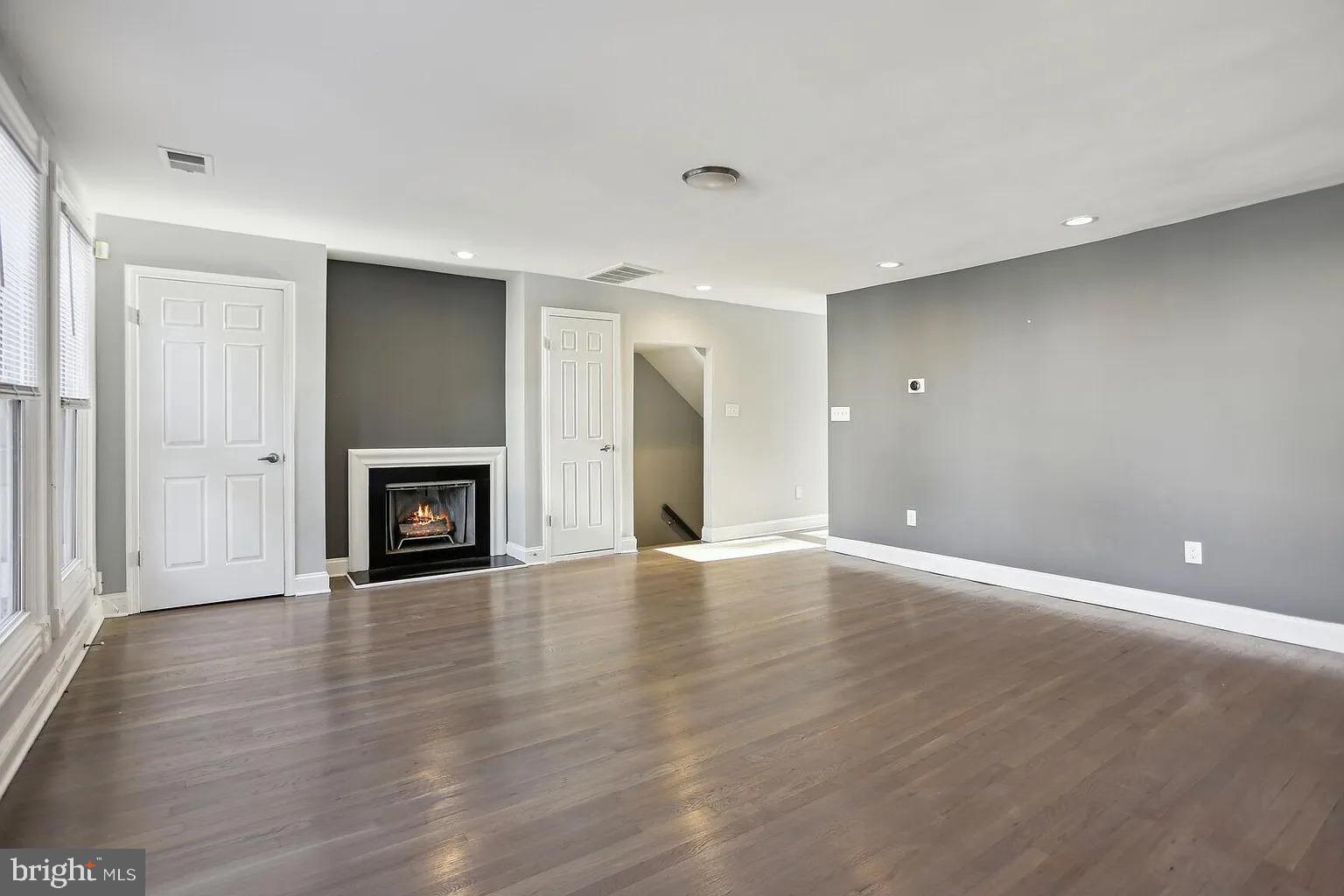 1507 Freedom Way Southeast, Unit 2 Washington, DC 20003 - Photo 4 of 22 a view of an empty room with wooden floor and a window