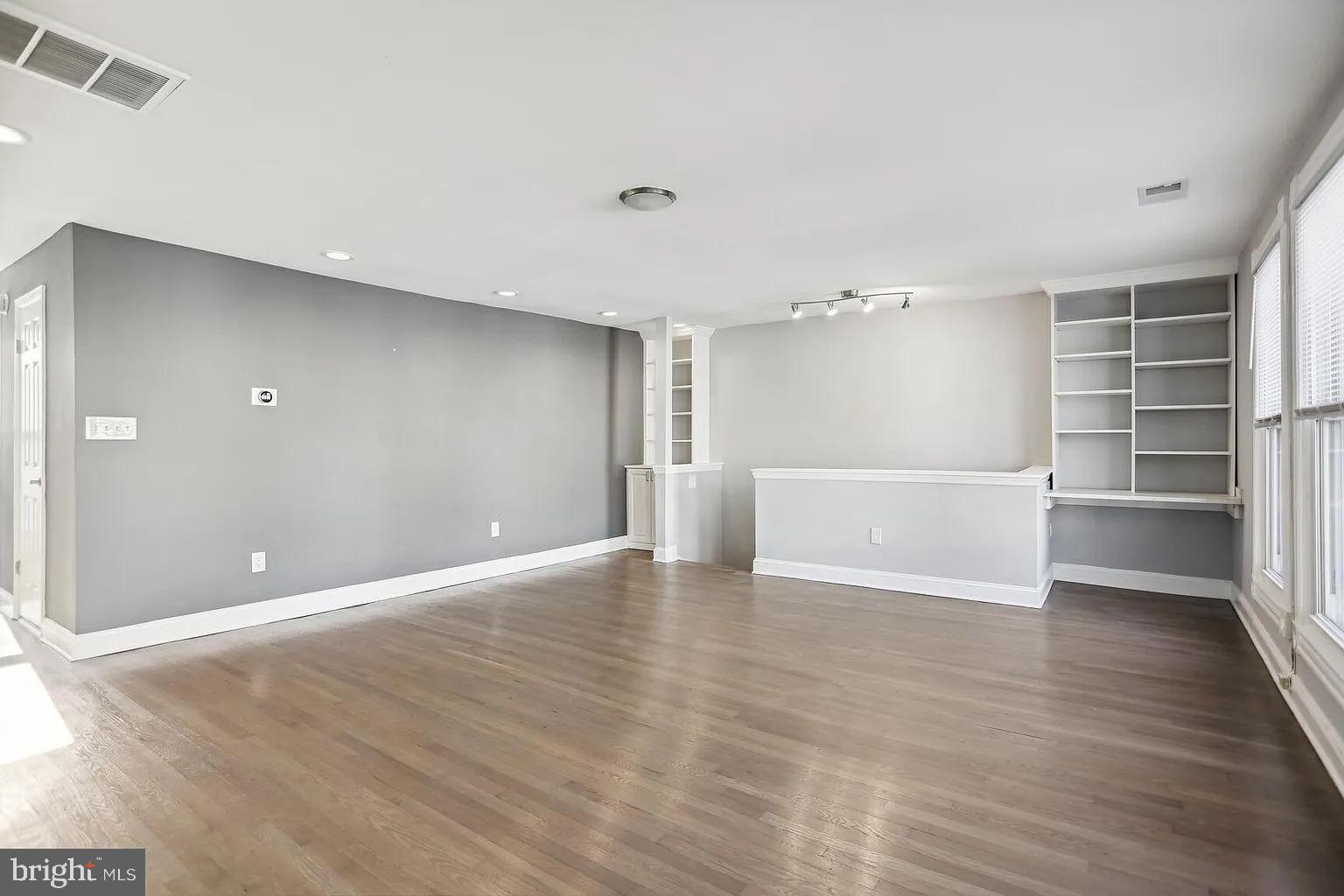 1507 Freedom Way Southeast, Unit 2 Washington, DC 20003 - Photo 6 of 22 a view of an empty room with a window and wooden floor