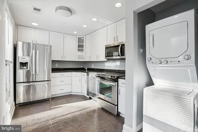 a kitchen with stainless steel appliances a refrigerator stove and microwave