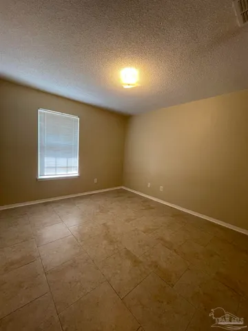 an empty room with a empty space and windows