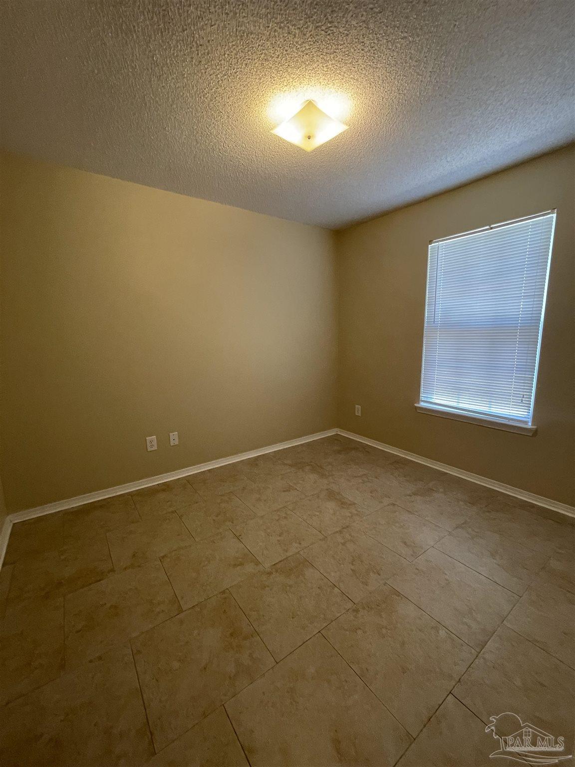 6208 St Ann Avenue Milton, FL 32570 - Photo 13 of 20 an empty room with a empty space and windows
