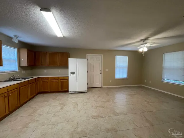a view of a kitchen with a sink and a stove top oven