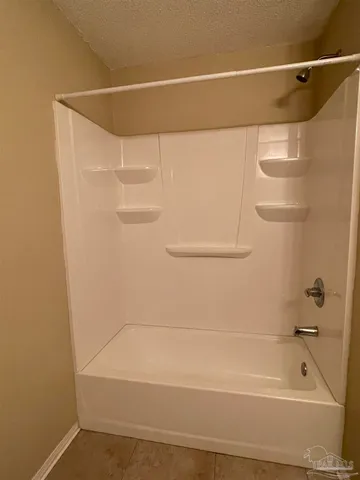 a bathroom with a shower and a bath tub