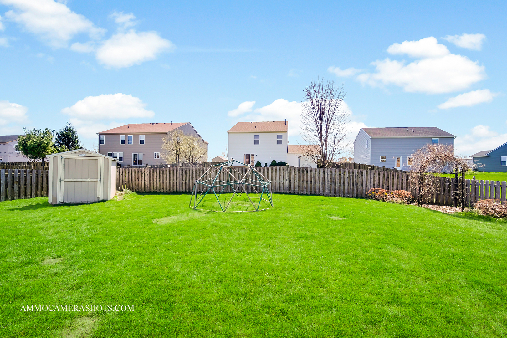 617 Kennedy Street Waterman, IL 60556 - Photo 25 of 32 a view of a backyard with a garden and wooden fence