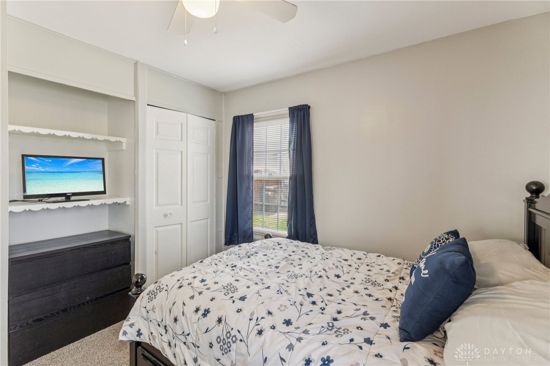 4934 Castleton Drive Fairfield, OH 45014 - Photo 18 of 36 This cozy bedroom features a ceiling fan, closet with bifold doors, and a window for natural light.