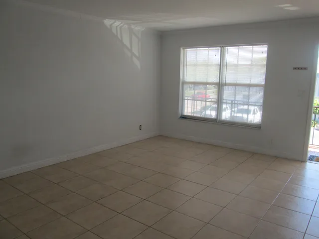 an empty room with a empty space and window