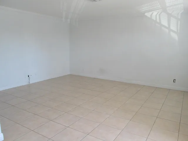 a view of an empty room and a window