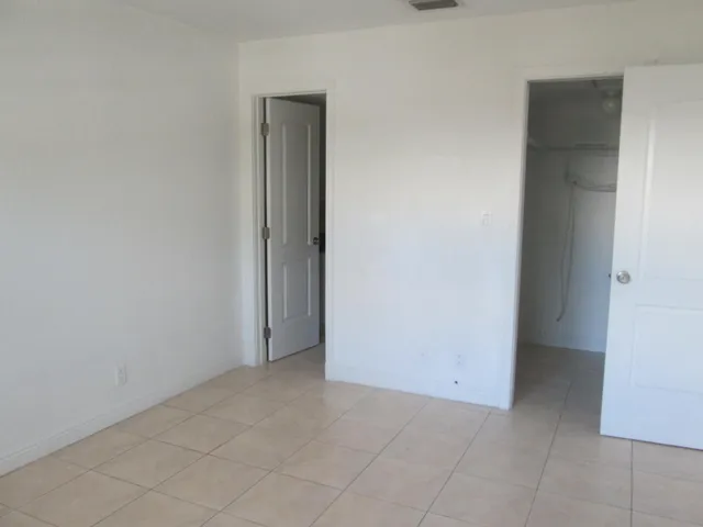 a white toilet sitting next to a shower