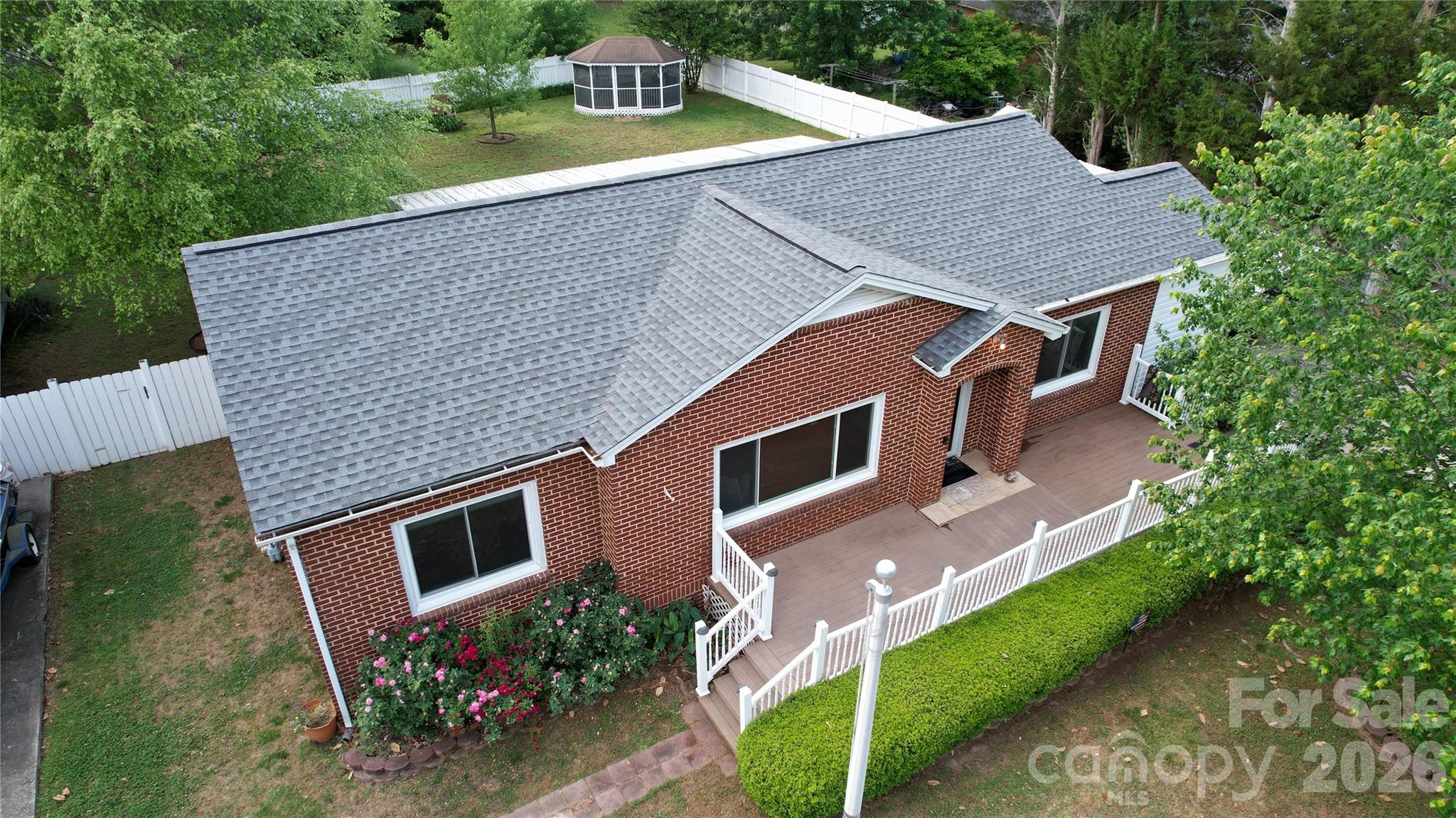204 Clinton Avenue Clover, SC 29710 - Photo 23 of 26 a aerial view of a house with yard and trees in the background
