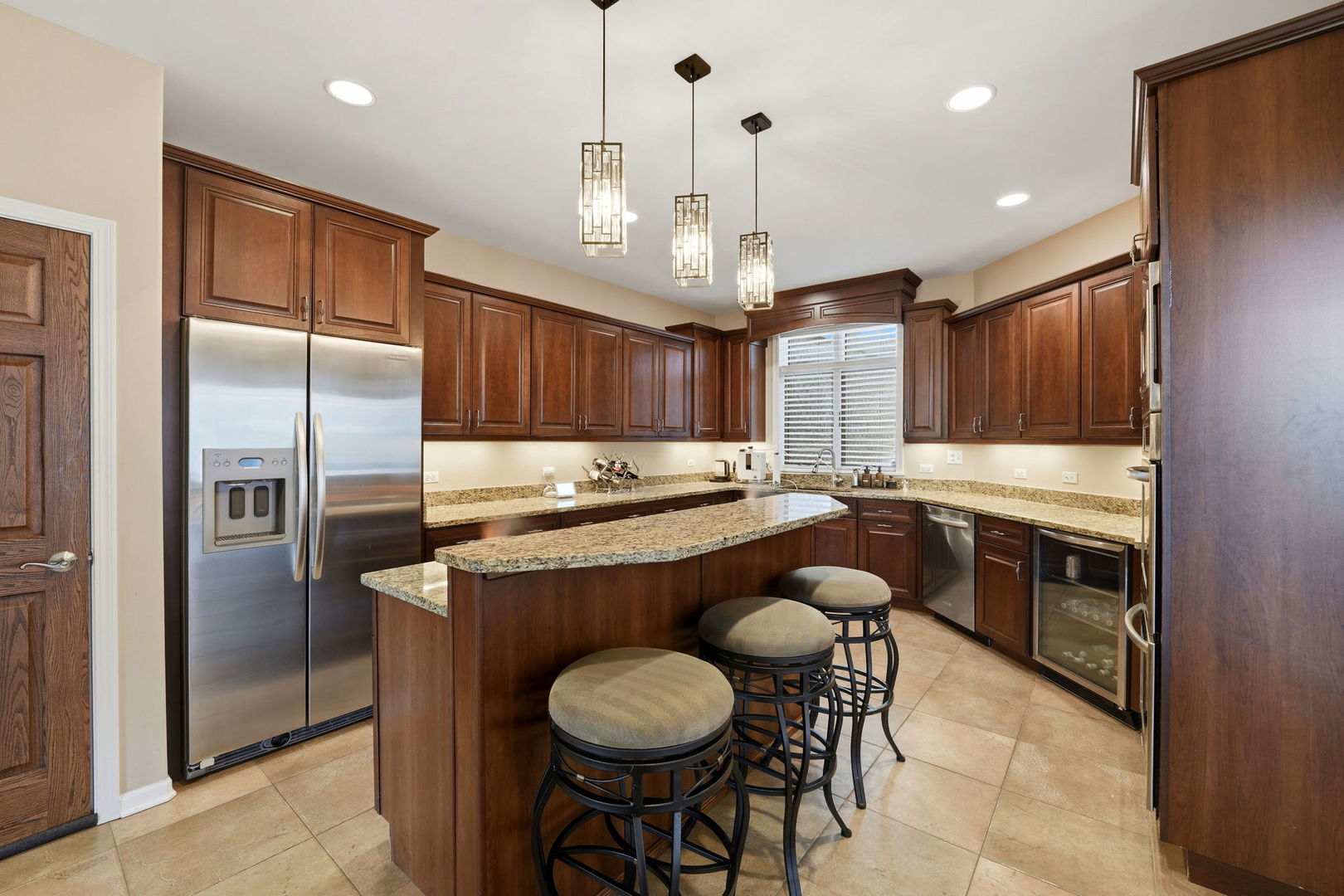 1406 Rue Paris Place Inverness, IL 60067 - Photo 13 of 35 a kitchen with stainless steel appliances granite countertop a sink a stove a refrigerator and wooden floor