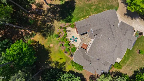 an aerial view of a house with a yard