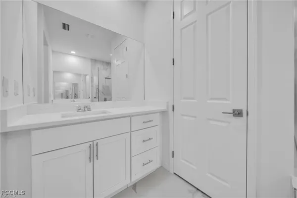 a bathroom with a double vanity sink and mirror