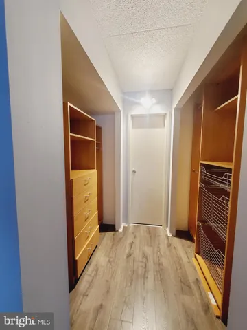 a view of hallway with stairs and wooden floor