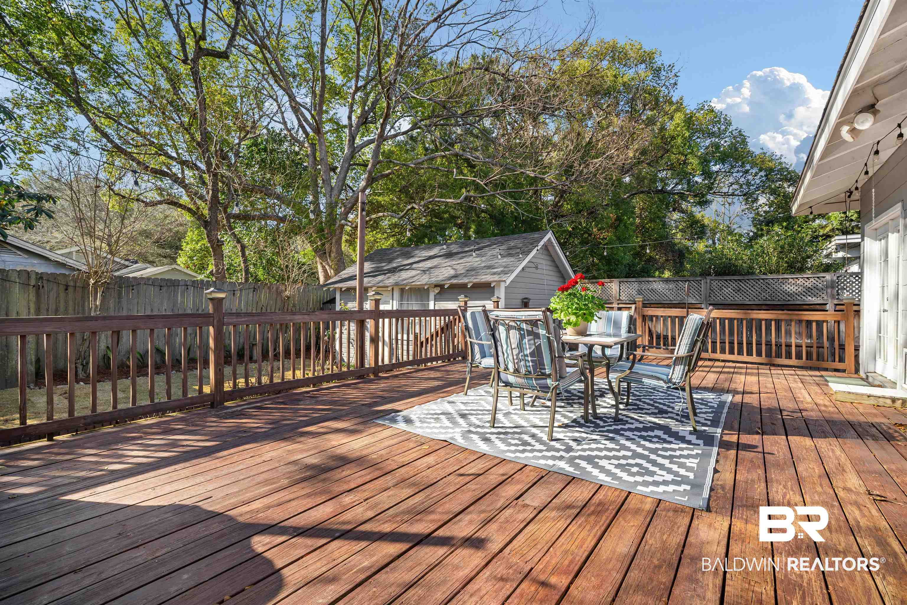 168 Mohawk Street Mobile, AL 36606 - Photo 28 of 31 Wooden terrace featuring a fenced backyard, an outdoor structure, and outdoor dining area