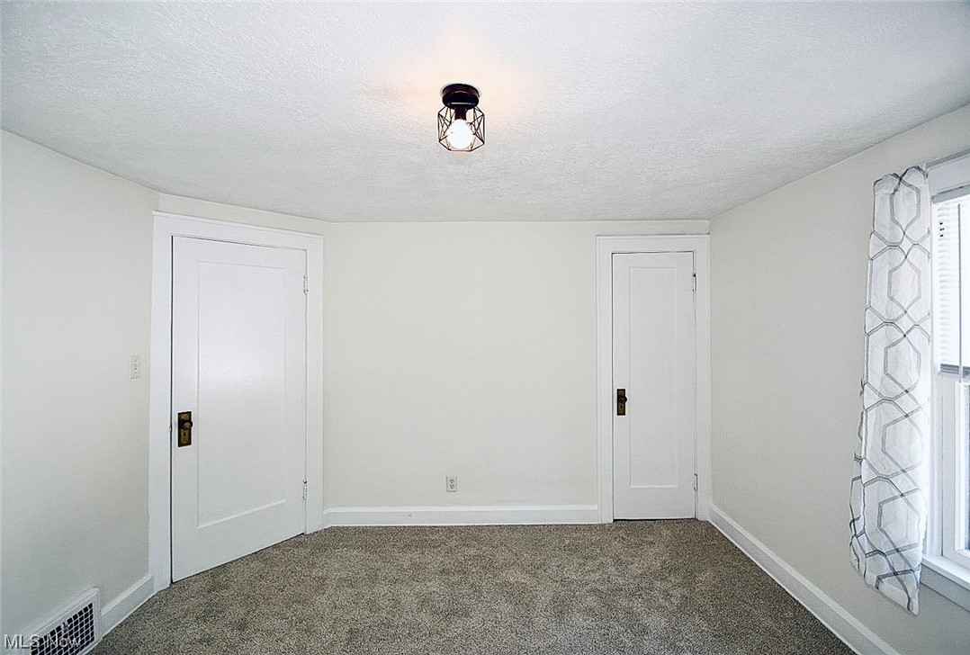 1233 Ridge Road Northwest Canton, OH 44703 - Photo 14 of 24 Carpeted master bedroom with a textured ceiling