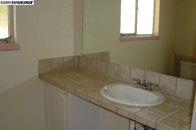 4378 South Roberts Road Stockton, CA 95206 - Photo 5 of 9 a bathroom with a sink and a window