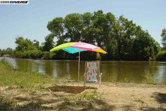 4378 South Roberts Road Stockton, CA 95206 - Photo 9 of 9 a view of a lake with a house