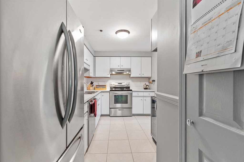 22 Railroad Street, Unit 504 Andover, MA 01810 - Photo 11 of 28 a kitchen with stainless steel appliances granite countertop a refrigerator sink and stove