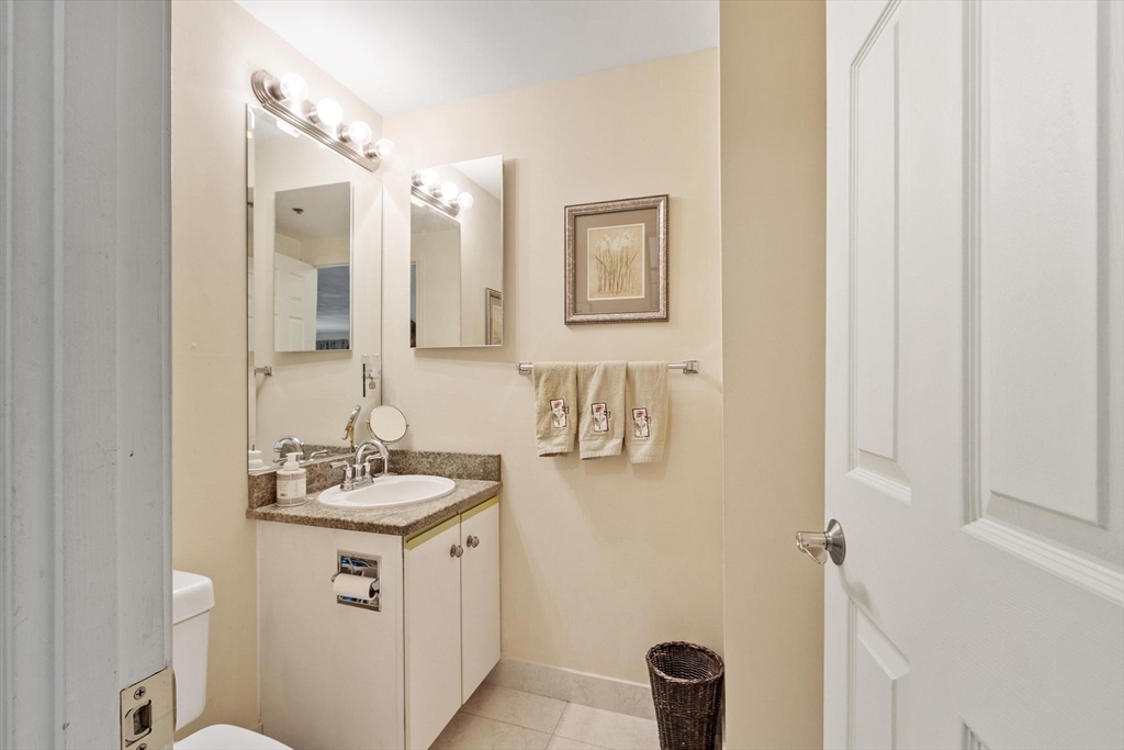 22 Railroad Street, Unit 504 Andover, MA 01810 - Photo 14 of 28 a bathroom with a sink a toilet and mirror