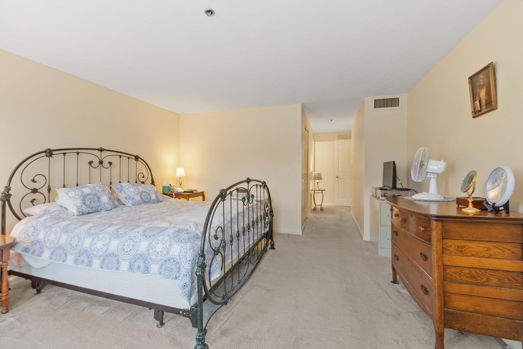 22 Railroad Street, Unit 504 Andover, MA 01810 - Photo 16 of 28 a bedroom with a bed and a car parked in it